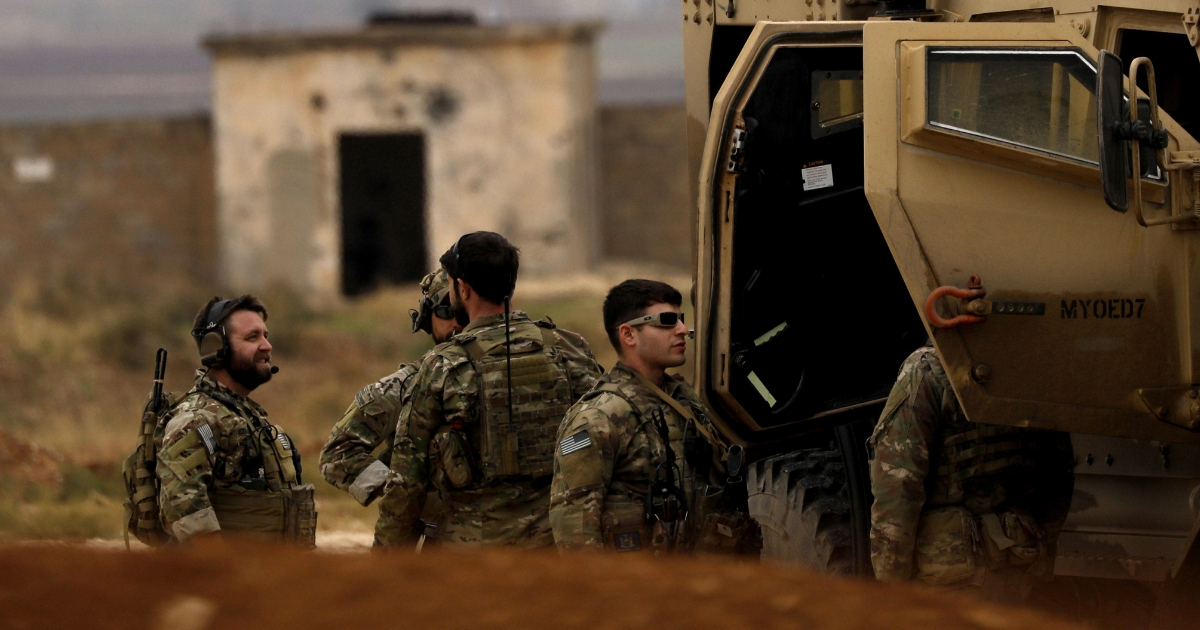 U.S. troops and members of the Syrian Democratic Forces patrol the Kurdish-held town of Al-Darbasiyah in northeastern Syria on Nov. 4.