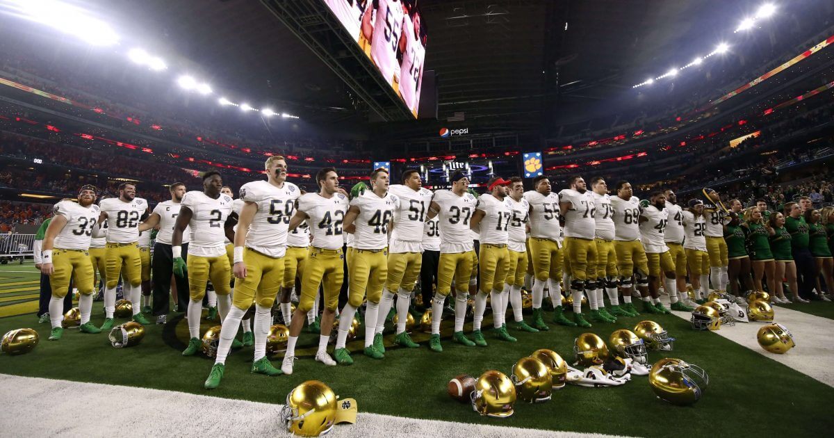 Notre Dame players stand in the end zone singing in the direction of their fans after their 30-3 loss to Clemson in the NCAA Cotton Bowl semi-final playoff football game, Saturday, Dec. 29, 2018, in Arlington, Texas. Clemson won 30-3.