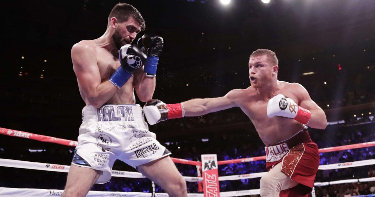 Mexico's Canelo Alvarez, right, punches England's Rocky Fielding during the second round of a WBA super middleweight championship boxing match on Saturday in New York. Alvarez stopped Fielding in the third round.