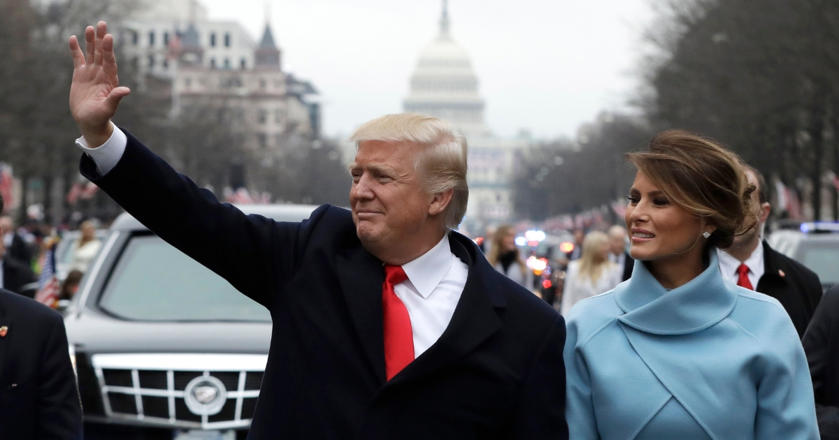President Donald Trump waves to supporters as he walks the parade route with first lady Melania Trump after being sworn in at the 58th Presidential Inauguration.