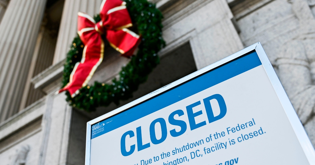 A sign is displayed at the National Archives building that is closed because of a US government shutdown in Washington, DC.
