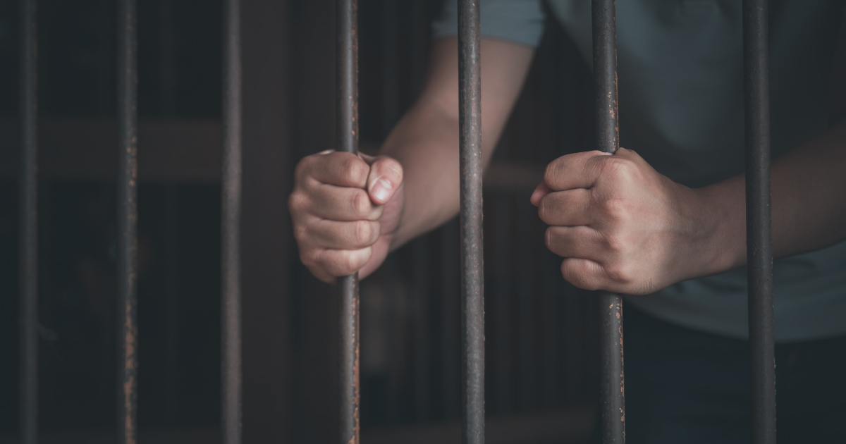 Man inside a jail cell.