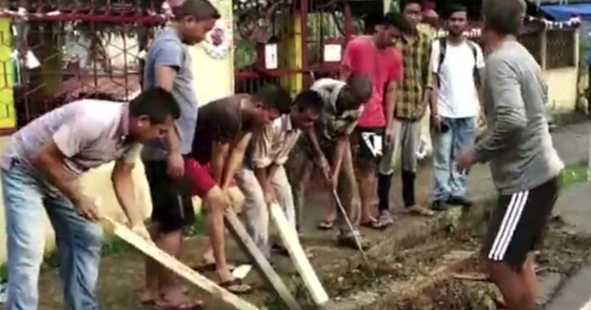 Men digging to help free puppies.