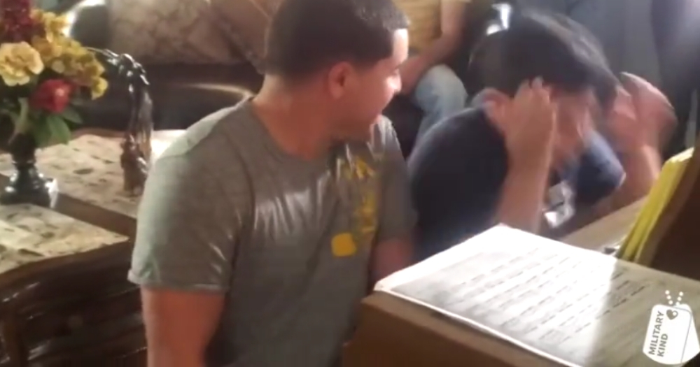 A Marine surprises his younger brother during piano performance.