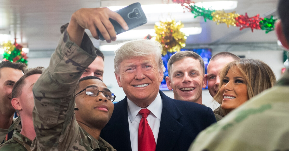 President Donald Trump and First Lady Melania Trump greet members of the US military during an unannounced trip to Al Asad Air Base in Iraq on December 26, 2018.