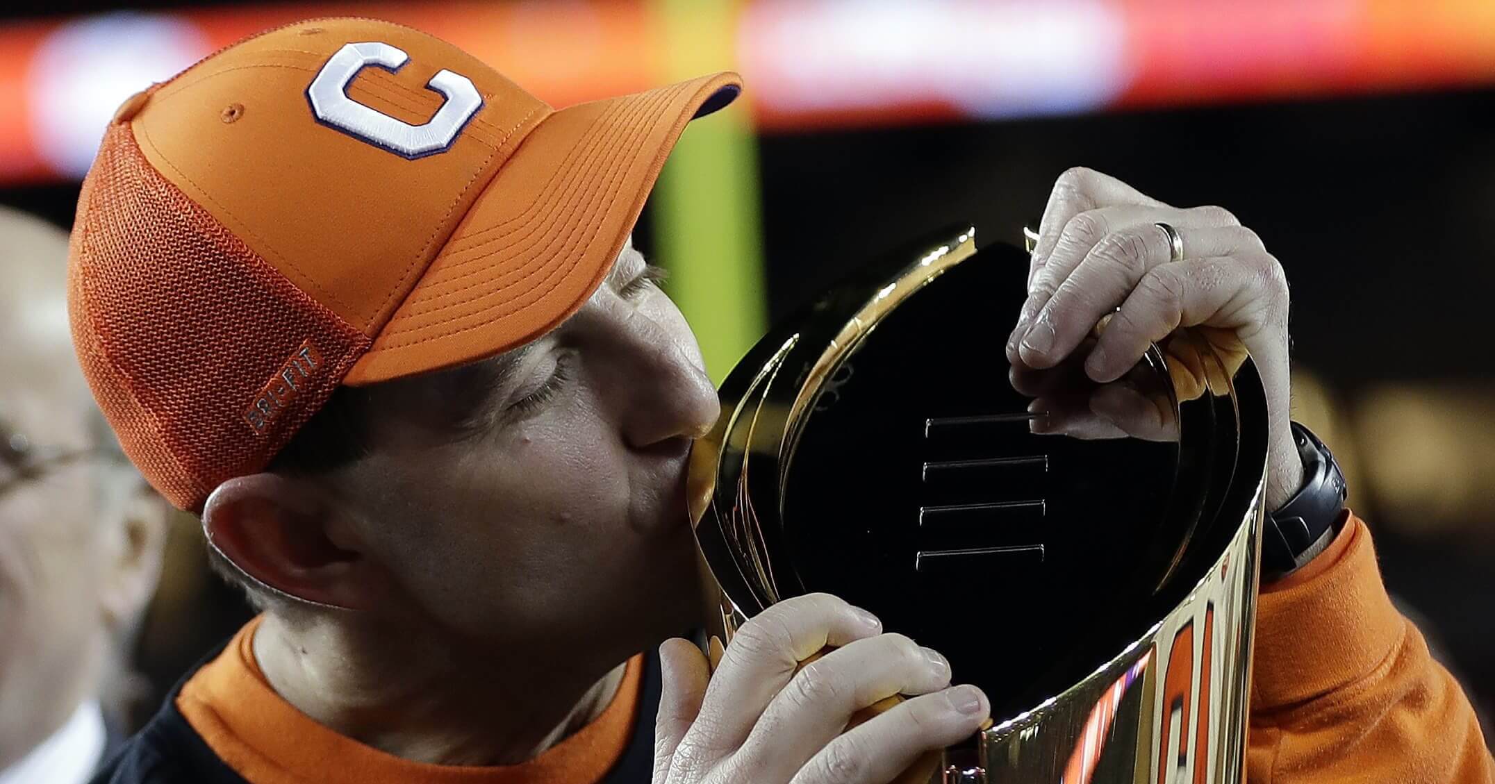 Clemson football coach Dabo Swinney kisses the national championship trophy after the Tigers routed Alabama on Monday night in Santa Clara, California.