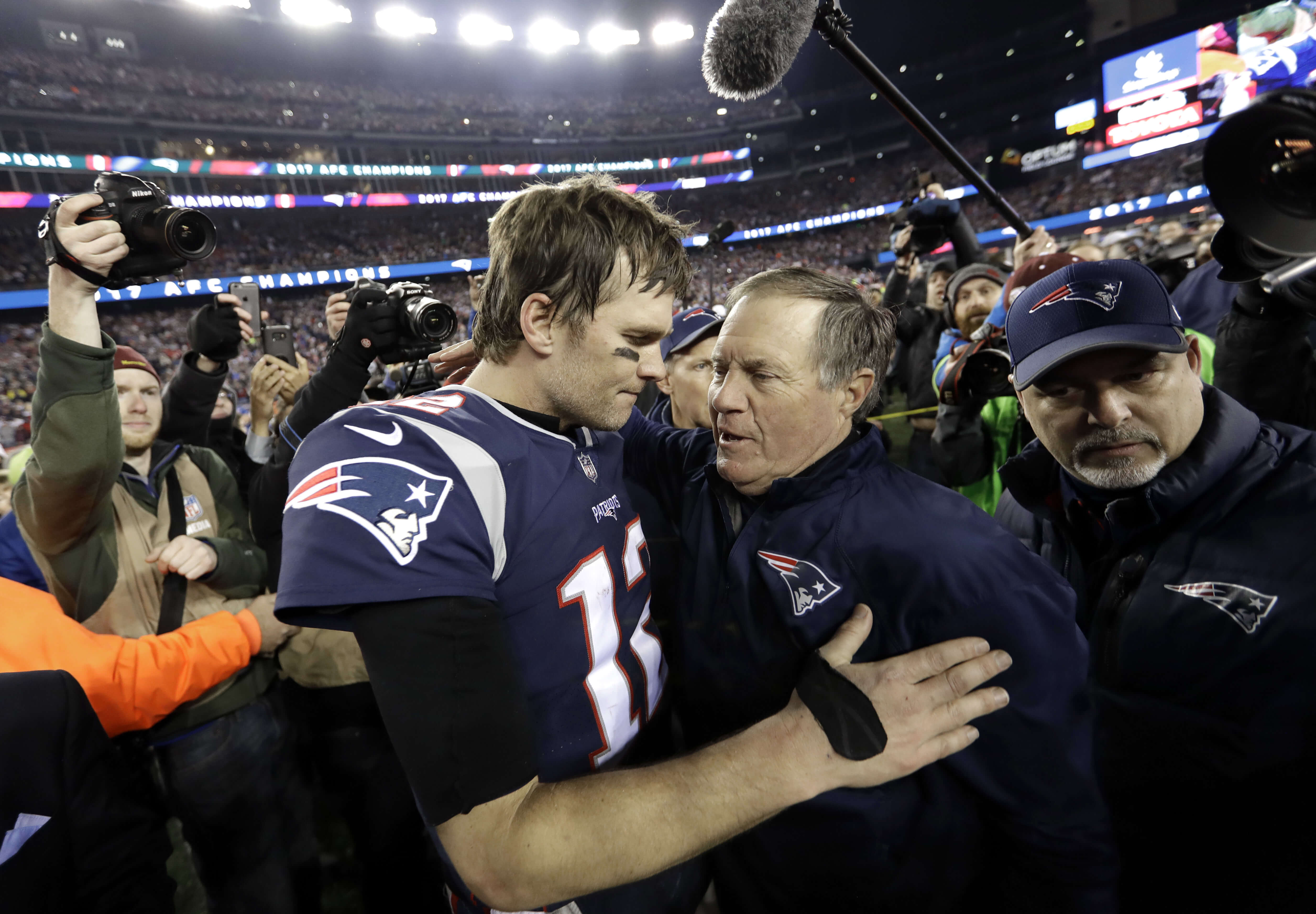 New England Patriots quarterback Tom Brady, left, hugs coach Bill Belichick on Jan. 21, 2018, after the AFC championship game against the Jacksonville Jaguars in Foxborough.