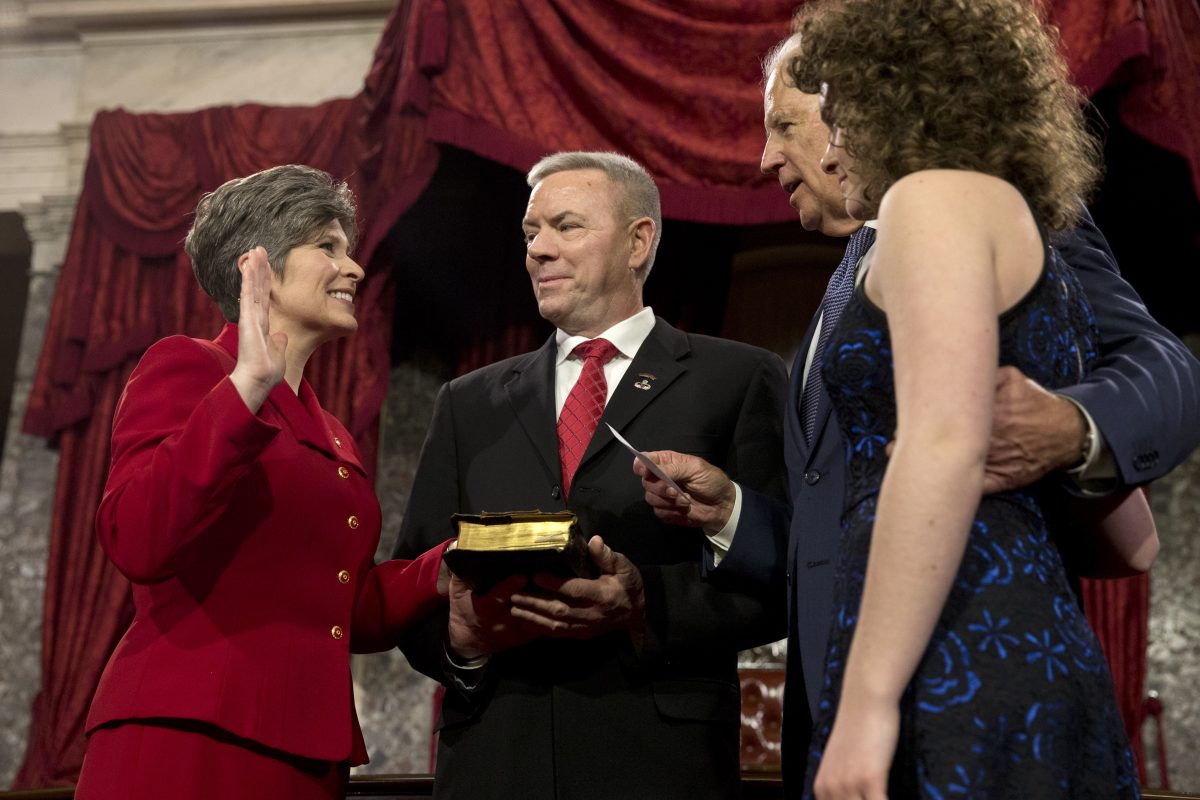 Vice President Joe Biden administers the Senate oath to Sen. Joni Ernst R-Iowa, with her husband Gail Ernst and daughter Elizabeth, during a ceremonial re-enactment swearing-in ceremony in the Old Senate Chamber of Capitol Hill in Washington.