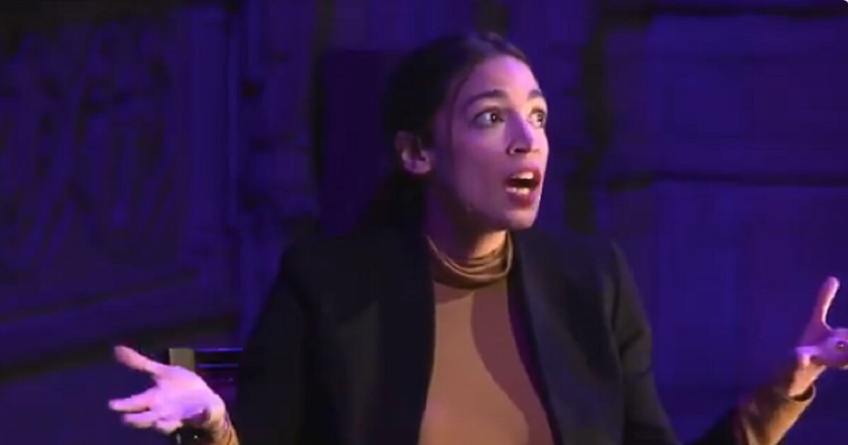 Alexandria Ocasio Cortez with her eyes wide open and mouth agape.