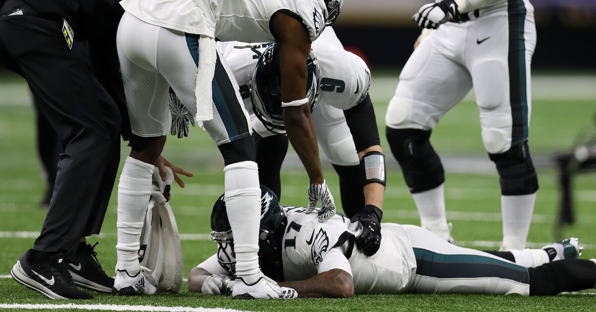 Philadelphia Eagles wide receiver Alshon Jeffery is consoled by his teammates Sunday after he missed a catch at the end of the team's playoff loss to the New Orleans Saints at the Mercedes Benz Superdome.