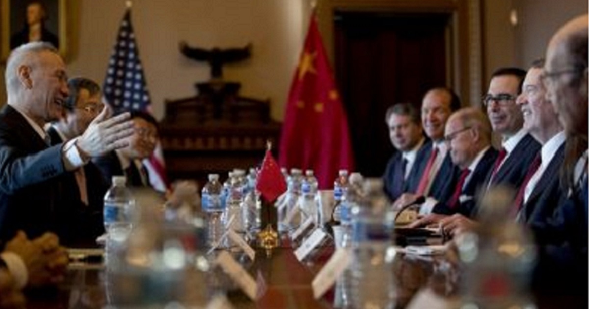 U.S. and Chinese trade representatives meet at a table Wednesday in Washington.