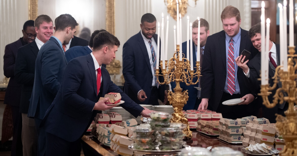 Members of the national champion Clemson Tigers choose from the fast-food options that President Donald Trump purchased for their visit to the White House on Monday.