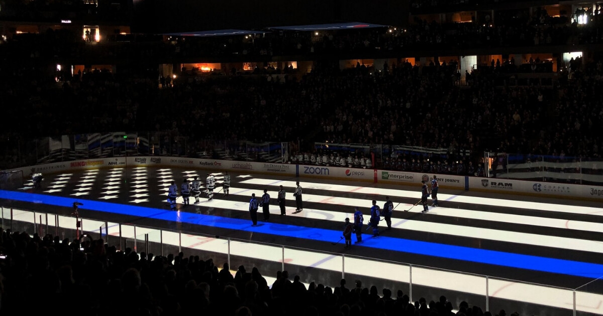 The NHL's Colorado Avalanche honor fallen police officers by projecting a "thin blue line" flag onto the ice before a game Saturday against the Los Angeles Kings.