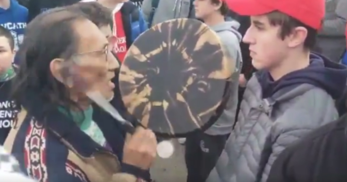 Man drumming in student's face.