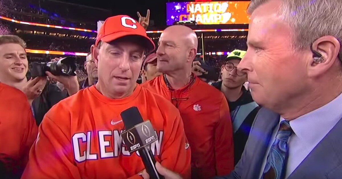 Clemson football coach Dabo Swinney gives an on-field interview with ESPN's Tom Rinaldi after his team beat Alabama in the College Football Playoff championship game.