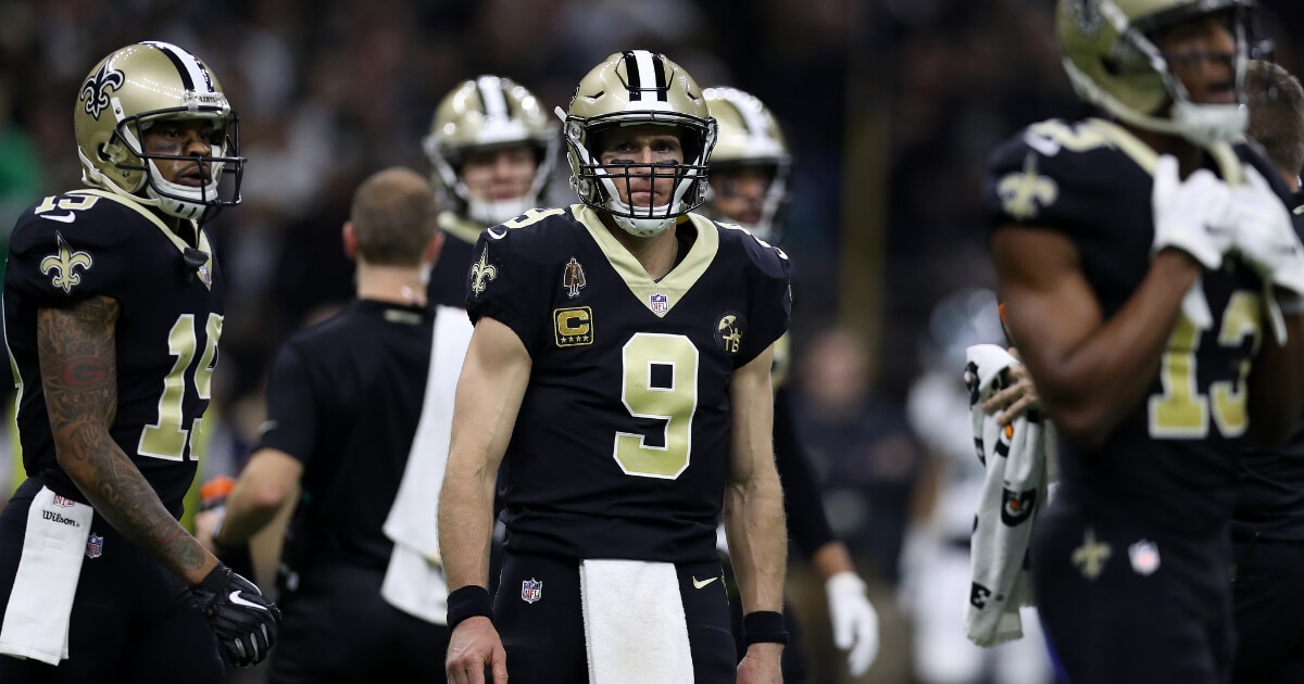 Drew Brees, center, and his New Orleans Saints teammates are seen during their NFC divisional playoff game Jan. 13 at the Mercedes Benz Superdome.