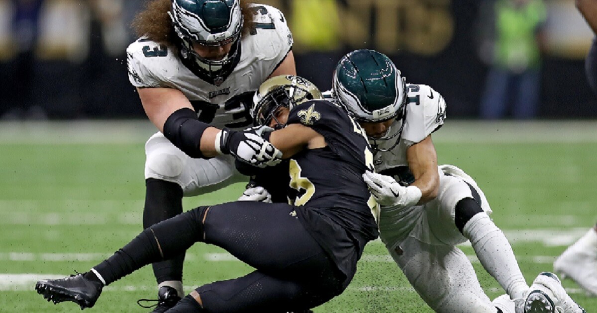 Marshon Lattemore of the New Orleans Saints is tackled after a fourth-quarter interception that sealed his team's victory Sunday over the Philadelphia Eagles in the Divisional Round of the NFL playoffs.