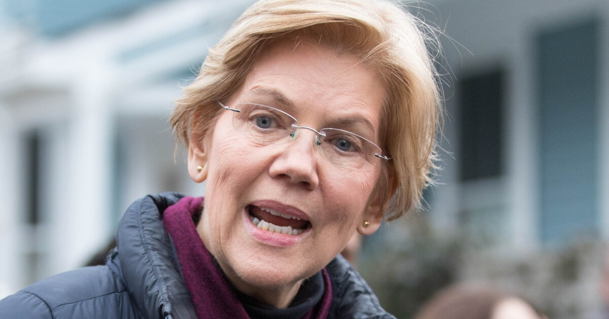 Sen. Elizabeth Warren, D-Mass., addresses the media outside of her home in Cambridge on Monday after announcing she formed an exploratory committee for a 2020 presidential run.