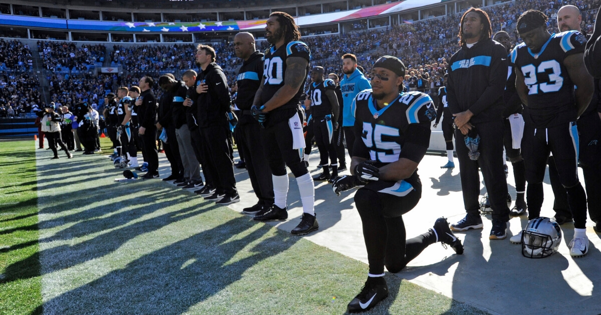 The Carolina Panthers' Eric Reid (No. 25) kneels during the national anthem before a Dec. 23 game against the Atlanta Falcons in Charlotte, North Carolina.