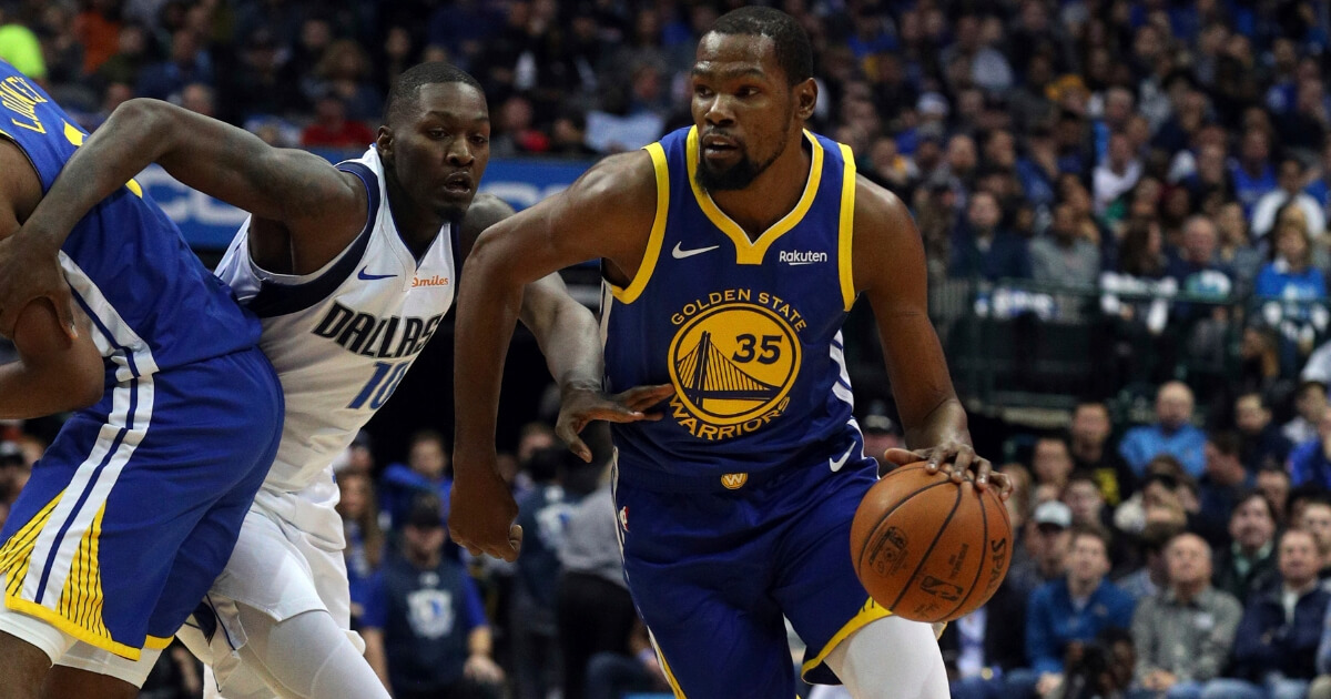 Golden State Warriors forward Kevin Durant (35) drives past Dallas Mavericks forward Dorian Finney-Smith (10) in the first half of an NBA basketball game, Jan. 13, 2019, in Dallas.