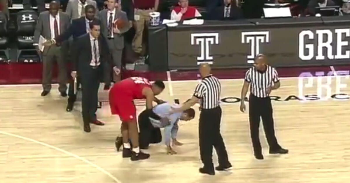 Houston basketball coach Kelvin Sampson went to his hands and knees as if gut-punched after his undefeated Cougars lost on a late charging call.