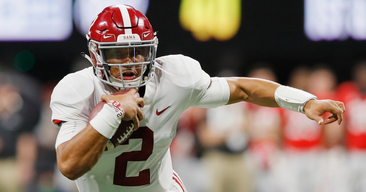 Jalen Hurts of the Alabama Crimson Tide runs with the ball in the fourth quarter against the Georgia Bulldogs during the 2018 SEC championship game at Mercedes-Benz Stadium on Dec. 1.