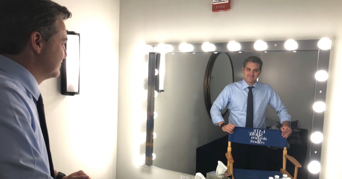 Jim Acosta smiles at himself in the mirror