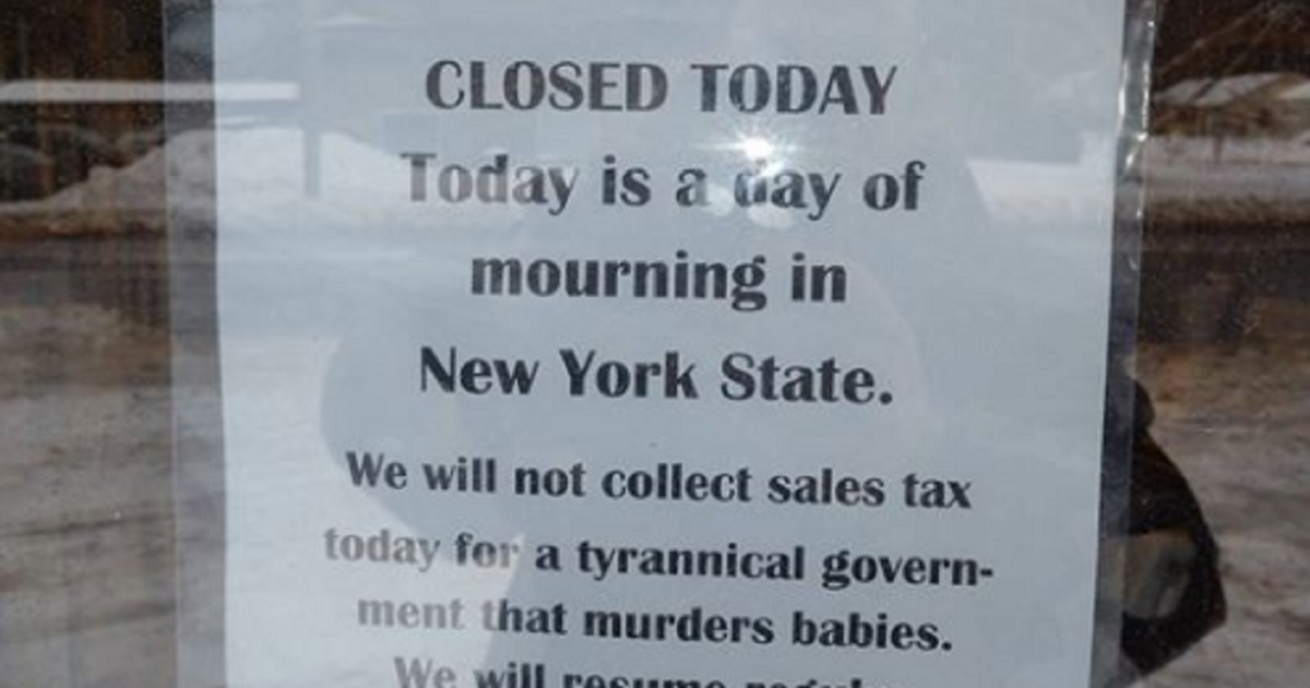A sign posted at a Syracuse, New York, book store announces the business was closed on Wednesday to protest a liberal new abortion measure signed into law by Democratic Gov. Andrew Cuomo on Tuesday.