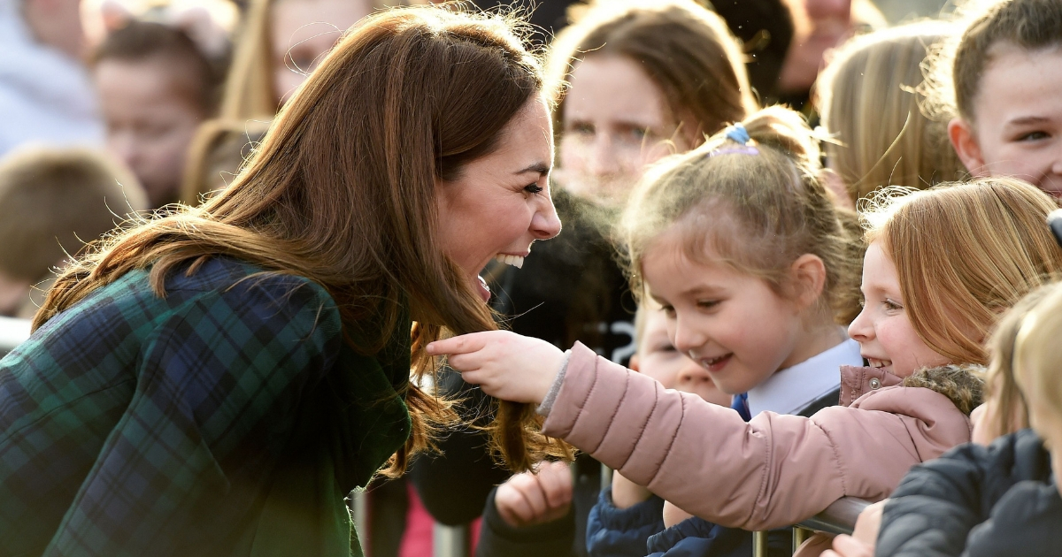 Britain's Catherine, Duchess of Cambridge reacts as a young girl touches her hair whilst she greets well-wishers outside of a community center in Dundee, eastern Scotland, on Jan. 29, 2019.