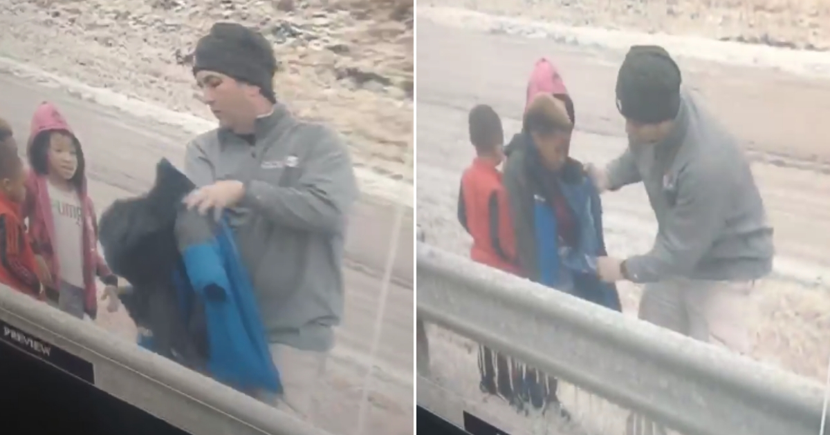 Meteorologist takes off jacket and gives it to children.