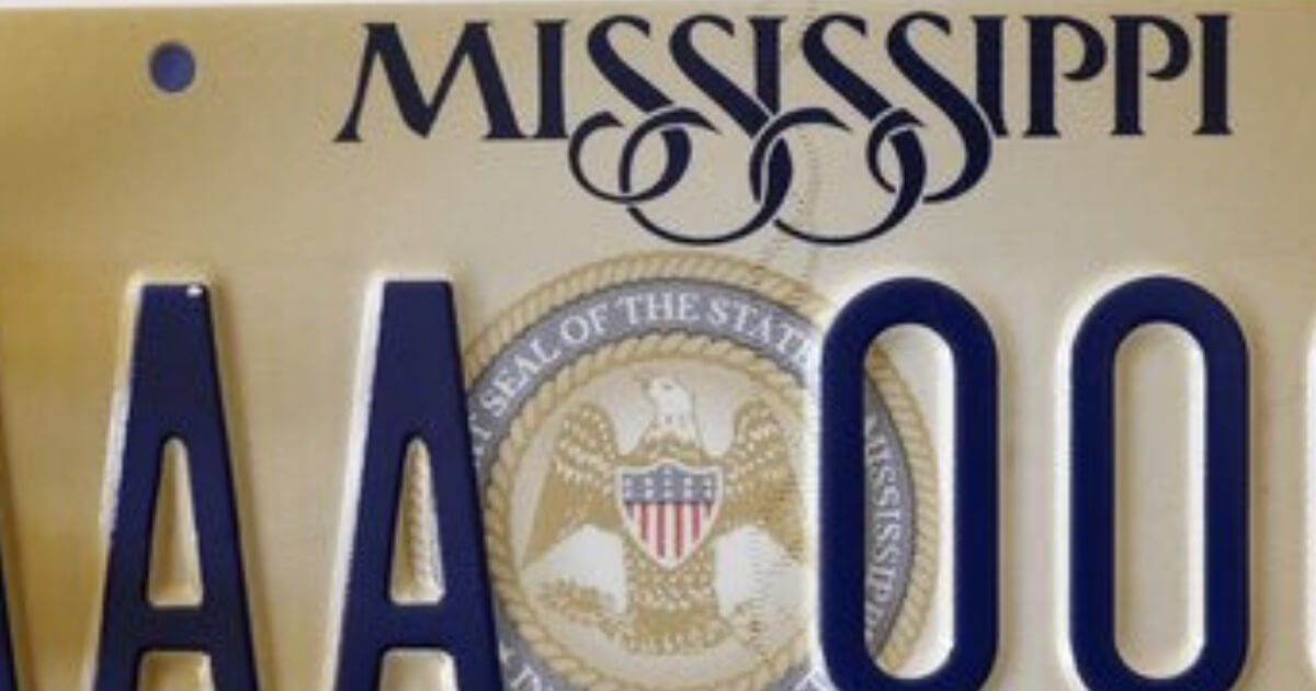A close-up of the new Mississippi license plate featuring the words "In God We Trust."
