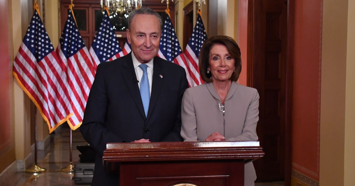 House Speaker Nancy Pelosi and Senate Democratic leader Chuck Schumer pose for pictures after delivering a response to President Donald Trump's televised address to the nation on border funding at the Capitol in Washington D.C. on Jan. 8, 2019.