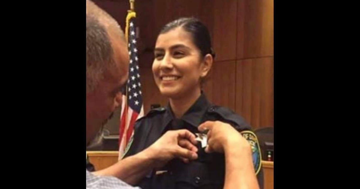 Woman getting a police badge.