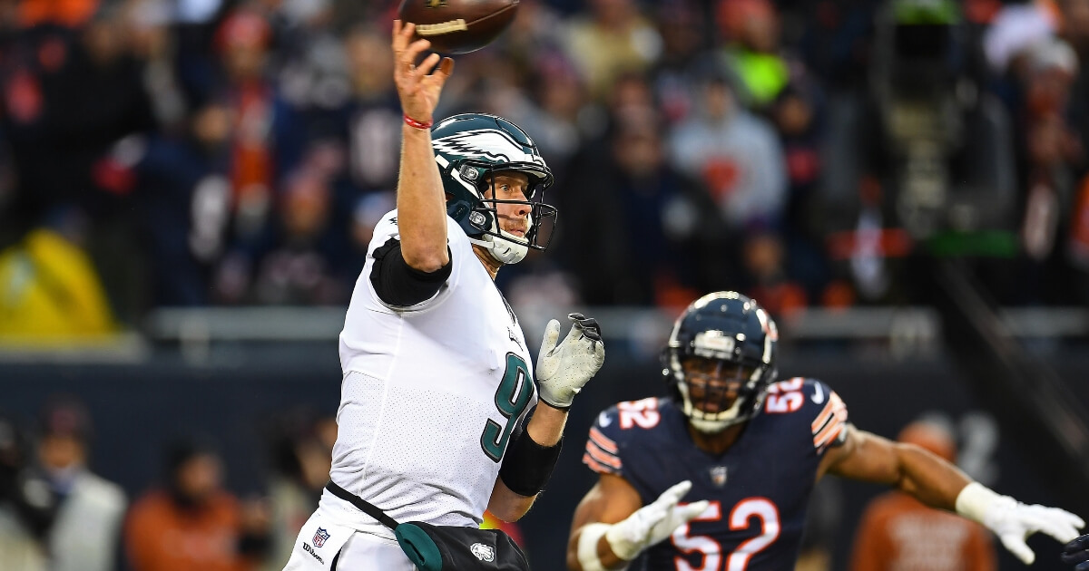 Nick Foles of the Philadelphia Eagles throws a pass while Khalil Mack of the Chicago Bears closes in during an NFC wild-card game Sunday at Soldier Field.