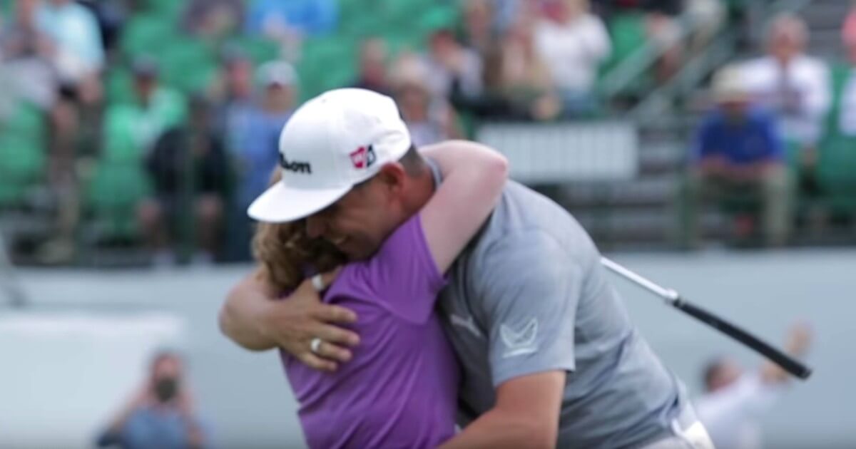 PGA Tour pro Gary Woodland hugs Amy Bockerstette during her par performance on the 16th hole Wednesday at the Waste Management Phoenix Open.