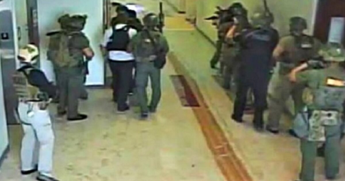Broward County sheriff's deputies gather in a hallway during the Feb. 14, 2018, mass shooting at Marjory Stoneman Douglas High School in Parkland, Florida.