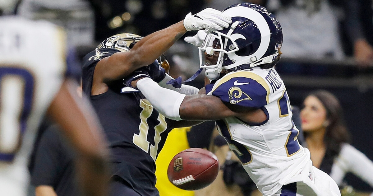 Los Angeles Rams cornerback Nickell Robey-Coleman hits New Orleans receiver Tommylee Lewis before the ball arrives on a play late in the NFC championship game Sunday at the Mercedes-Benz Superdome.