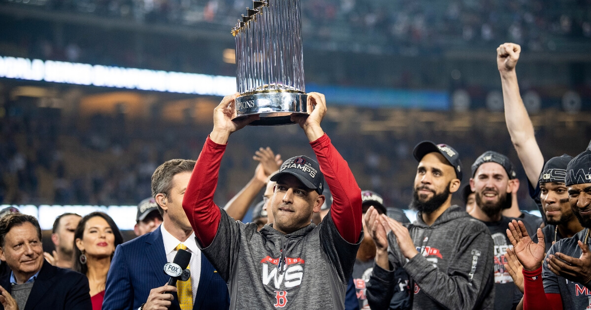 Manager Alex Cora of the Boston Red Sox holds up the World Series trophy after his team won Game 5 against the Los Angeles Dodgers on Oct. 28, 2018, at Dodger Stadium.