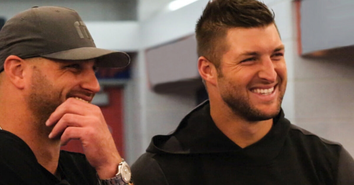 Brothers Robby, left, and Tim Tebow on the set of "Run the Race," an upcoming film for which they are executive producers.