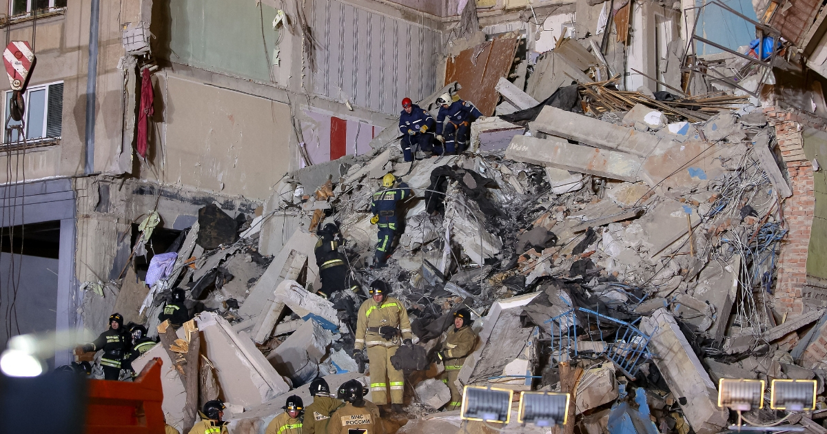 Emergency officers inspect rubble as they take part in a rescue operation after a gas explosion rocked a residential building in Russia's Urals city of Magnitogorsk on Dec. 31, 2018.