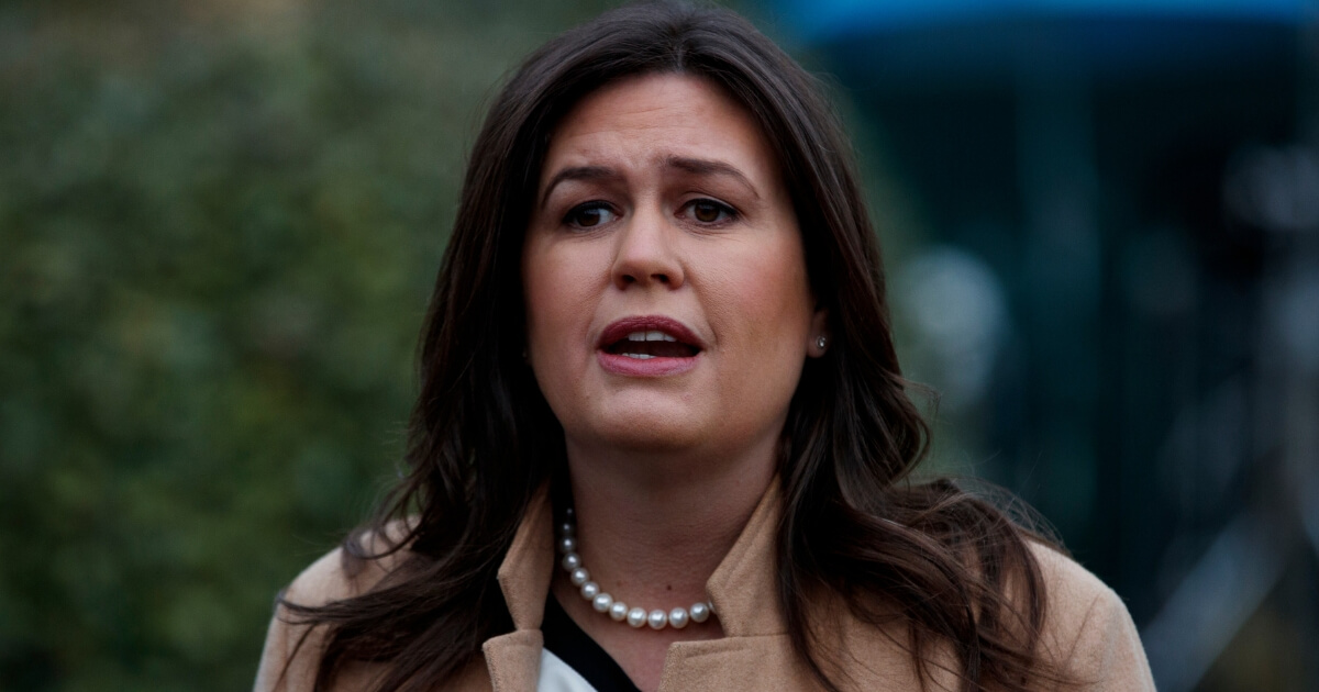 White House press secretary Sarah Sanders talks to reporters outside the White House on Friday.