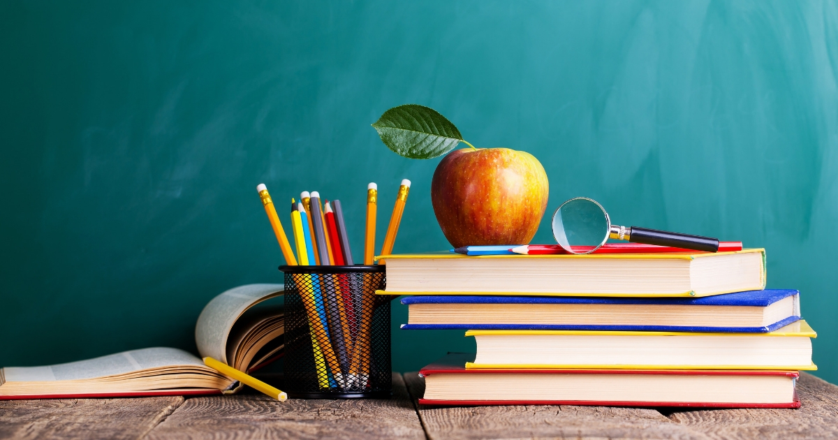 A stack of books with an apple on top