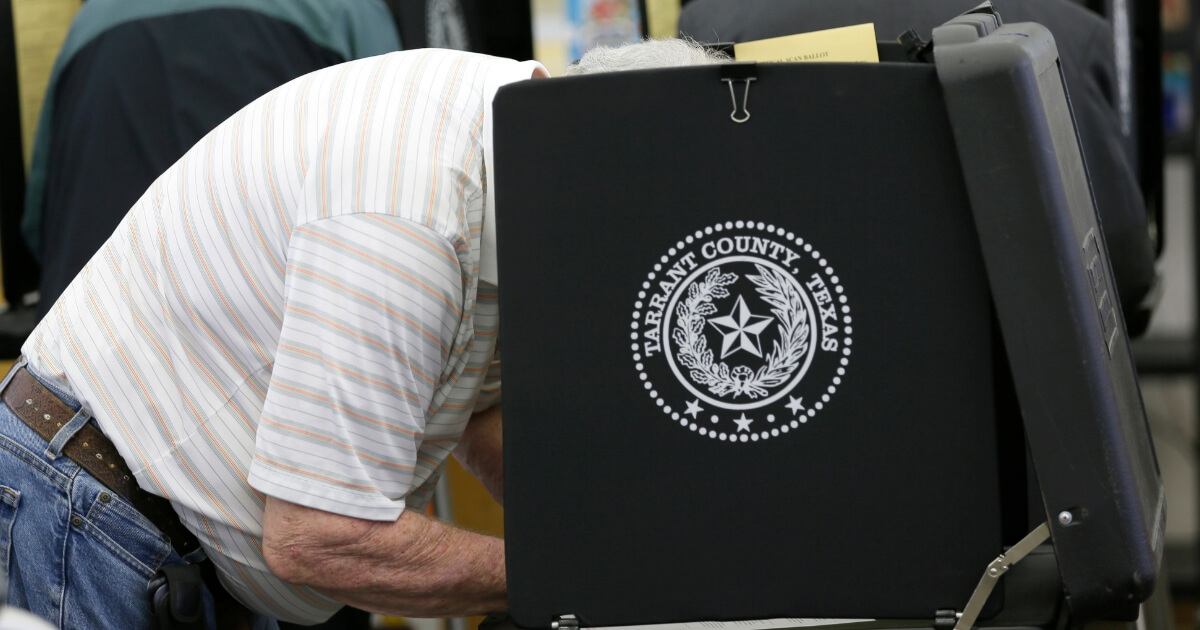 Voters make their choice in the ballot booth during voting in the primary election at Sherrod Elementary school in Arlington, Texas, March 1, 2016.