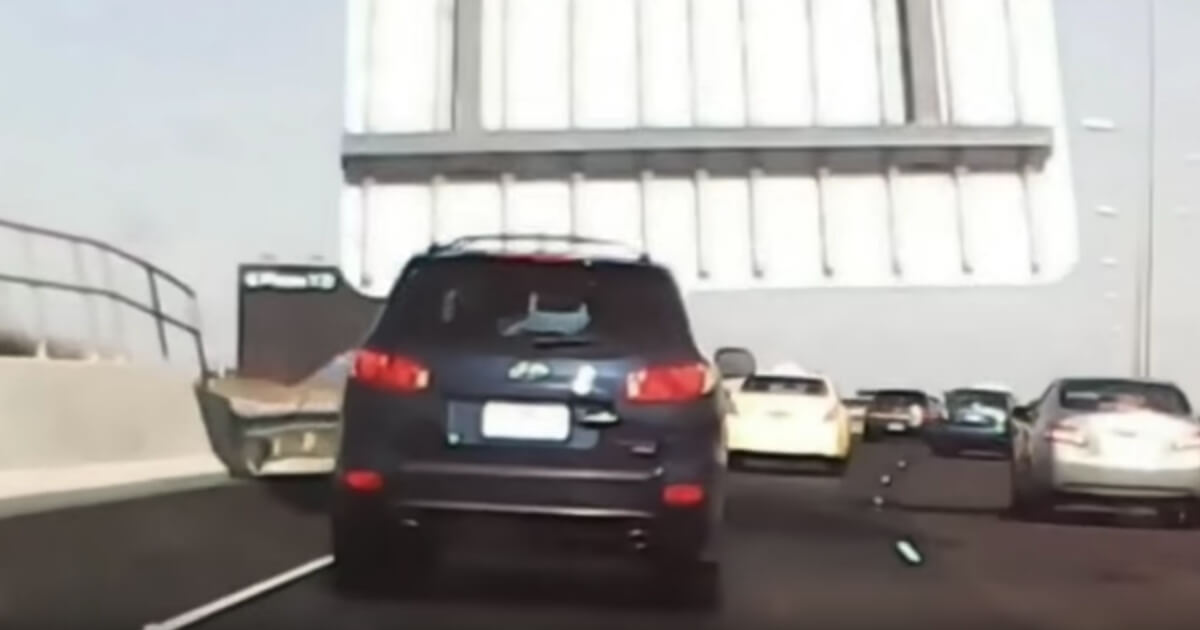 A freeway sign in Australia crashes down on an SUV.