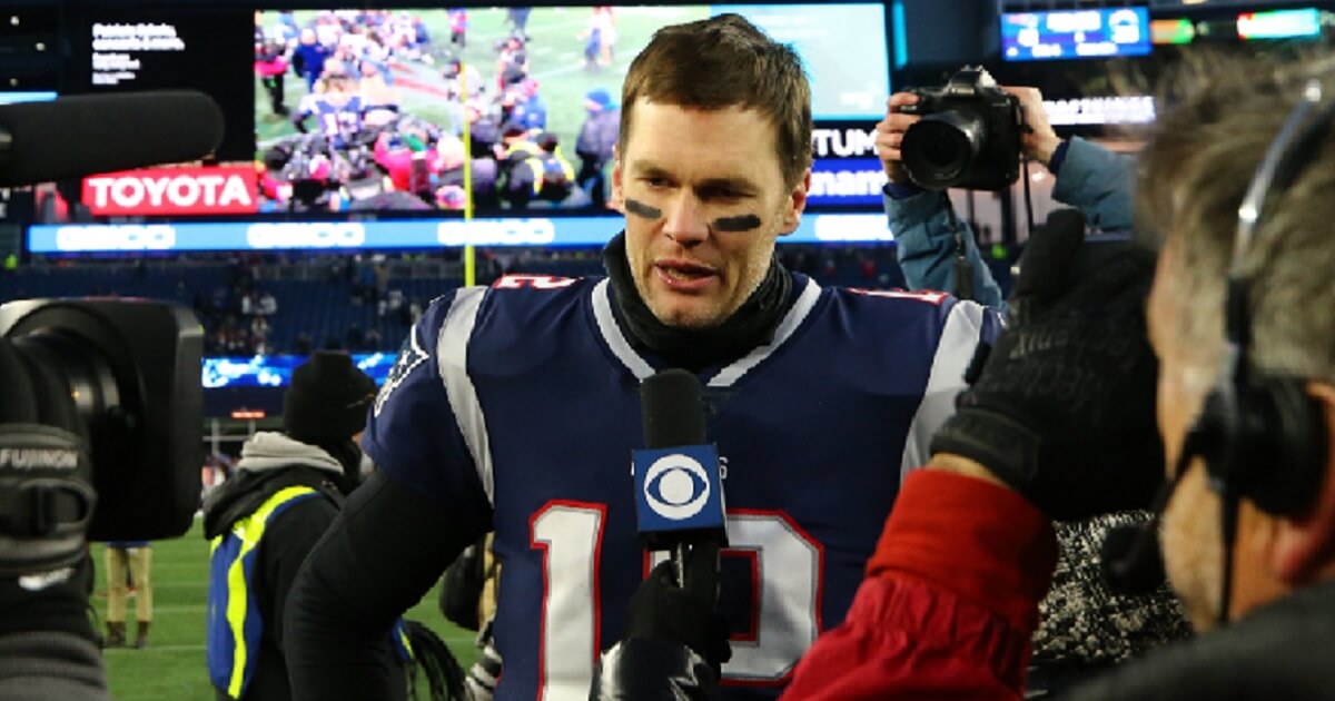 New England Patriots quarterback Tom Brady is interviewed on the field after his team's win against the Los Angeles Charges on Sunday.