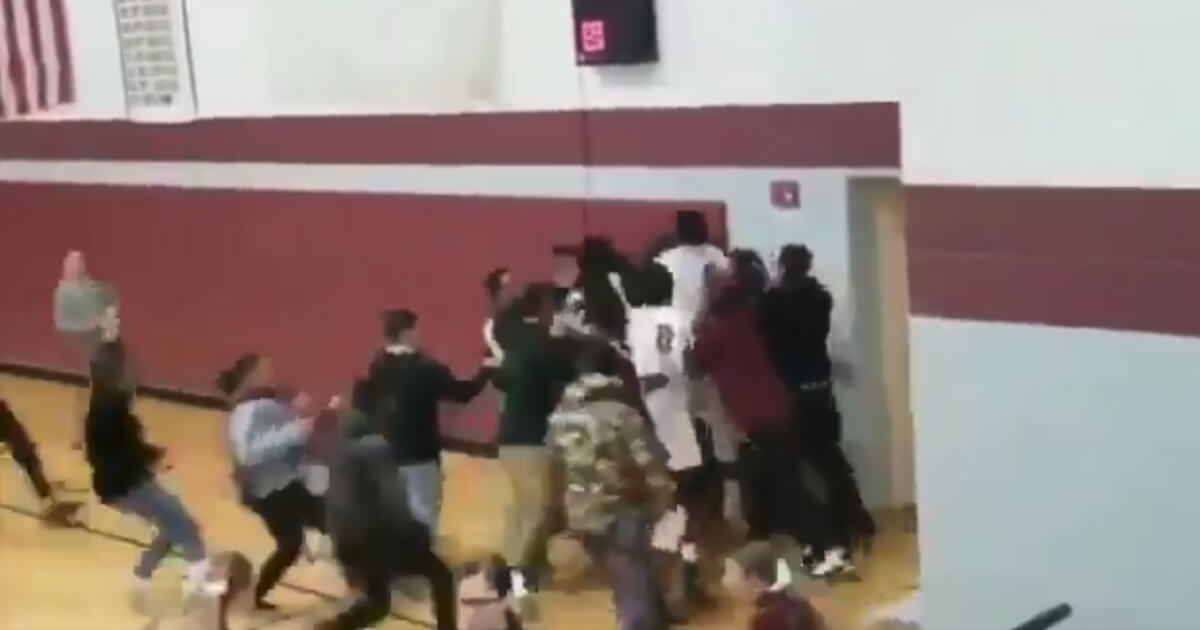 Students and players at Sabis International Charter High School in Springfield, Massachusetts, celebrate after sophomore guard Tre Hodge hit a three-quarter-court buzzer-beater to win the game.