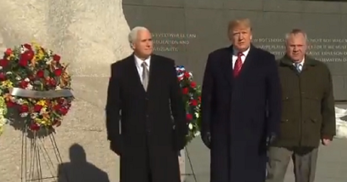 President Donald Trump with Vice President Mike Pence, left, paid an unannounced visit to the Martin Luther King memorial in Washington on Monday in honor of Martin Luther King Jr. Day.