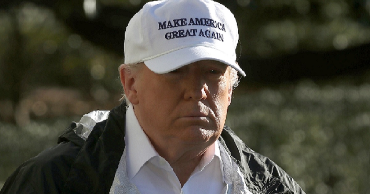 President Donald Trump in white "MAGA" hat.