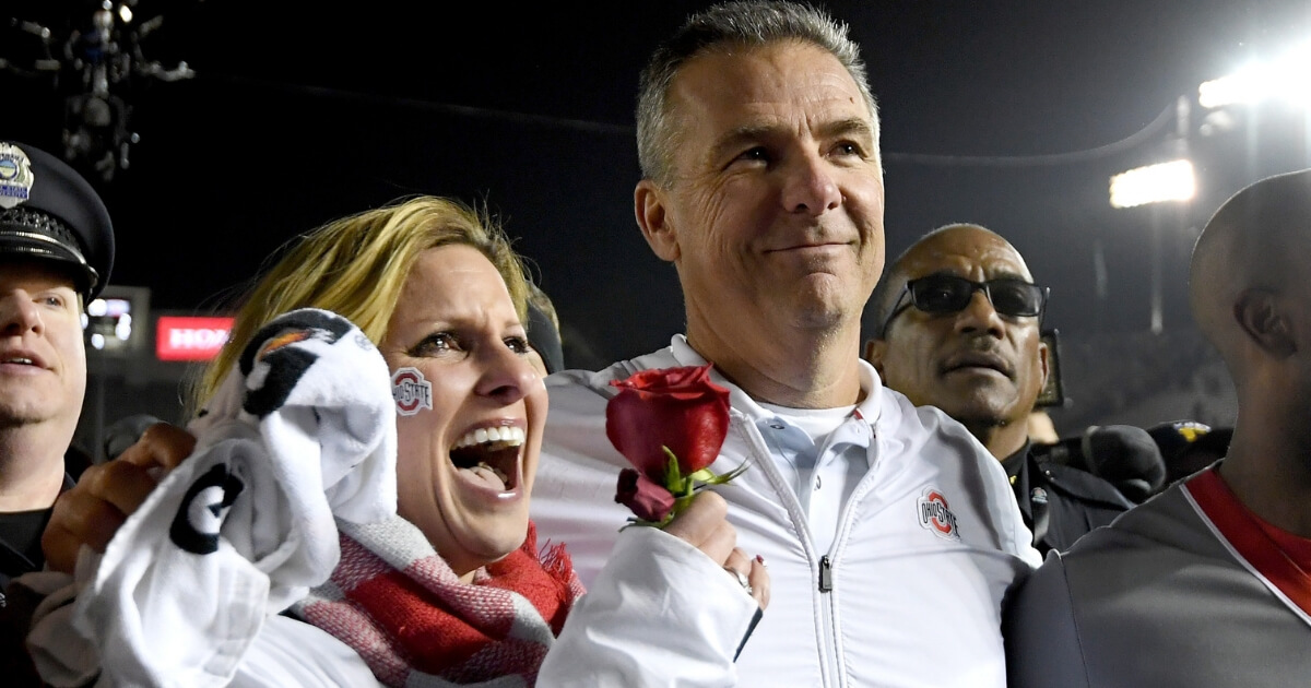 Ohio State football coach Urban Meyer and his wife, Shelley, celebrate after the Buckeyes won the Rose Bowl on Tuesday.