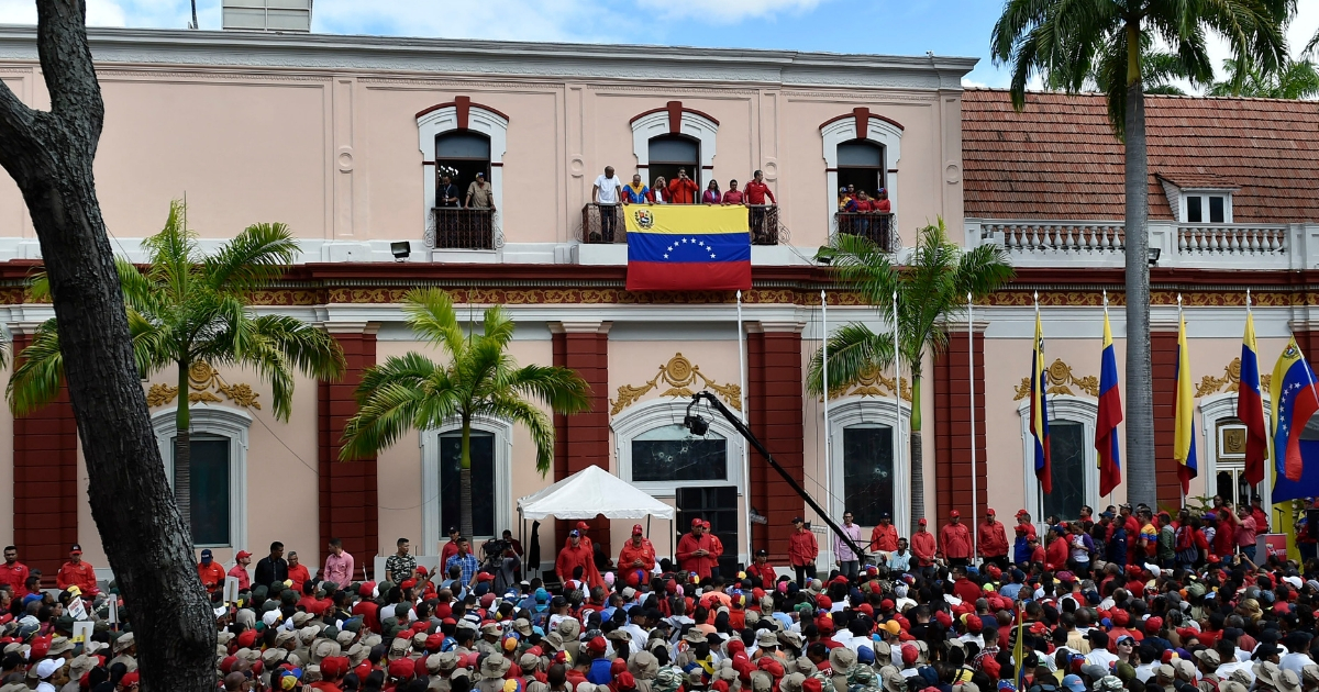 Venezuelan leader Nicolas Maduro, center, speaks to a crowd of supporters in Caracas on Wednesday to announce he is breaking off diplomatic ties with the United States.